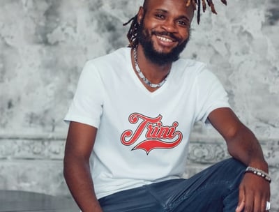 Man wearing a tshirt with the word Trini on the chest