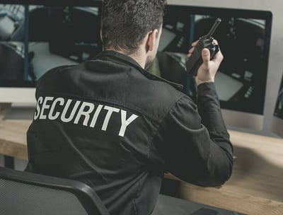 a security officer in uniform with a cell phone