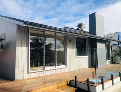 a house with a deck and a deck with a view of the ocean