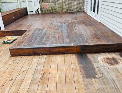 a wooden deck with a bench and a bench