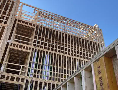 a wood paneling frame building being built with all Safety Measures by OSHA