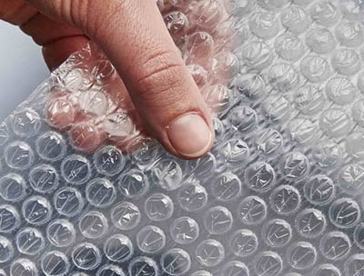 a person holding a piece of bubble bubble wrap