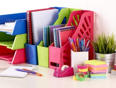 a desk with a bunch of office supplies and a desk with a desk top