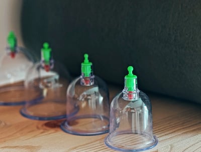 a group of small plastic bottles with green lids