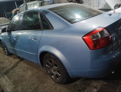 a Audi blue car parked in a garage