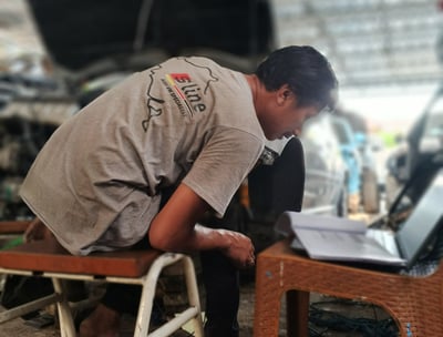 a man sitting on a chair with a laptop