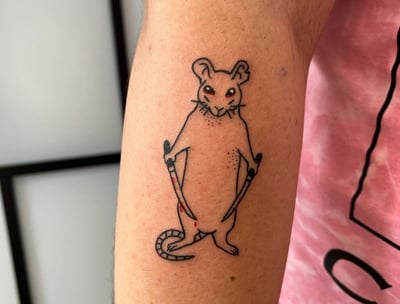 a mouse tattoo on the arm of a man made at Inari Tattoo