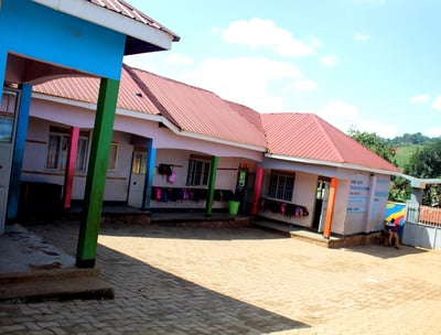 a building with a colorful painted wall and a colorful umbrella