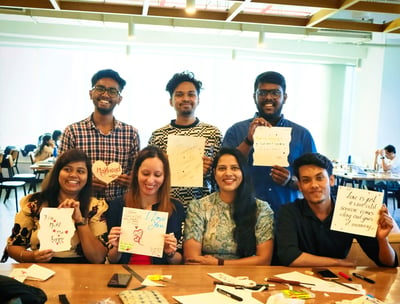 a group of employees holding up signs that say thank