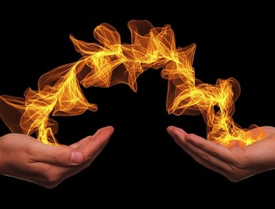 two hands holding a firework in the shape of a circle