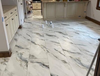 a kitchen floor with a mop and a mop