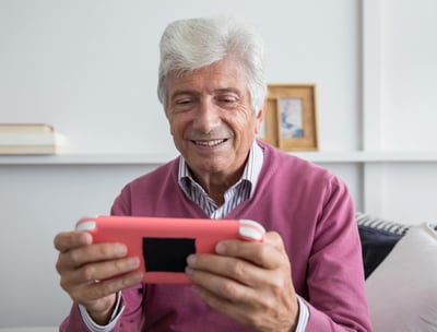 a man in a pink sweater and sweater with a pink phone