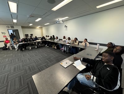 a group of youth sitting at tables in a room