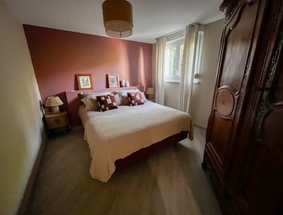 a bedroom with a bed and a wooden cabinet