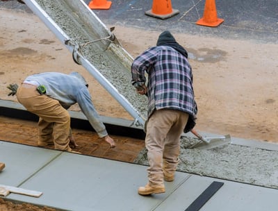 two men working on a concrete slab