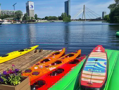 Kayaks and a SUP board at the Party Port Riga