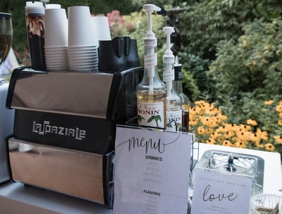 Espresso machine and flavored syrups set up for a corporate coffee cart event
