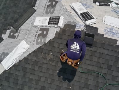 roofer installing shingles