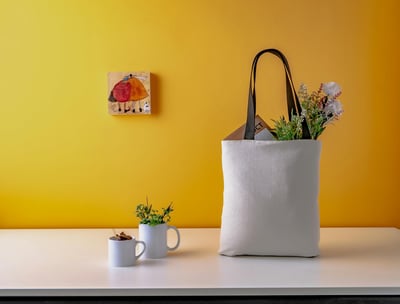 flowers in a tote bag and custom mugs