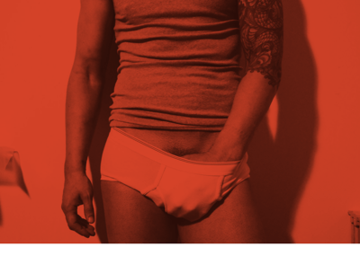 Toronto Gay Escort & Nude Male Massage by Nick Rivera | A red filtered photo of Nick in white briefs