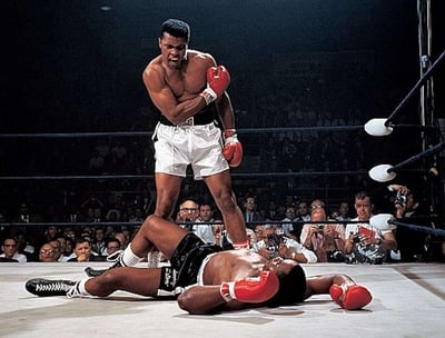 Boxing legend Muhammad Ali stands over fallen opponent
