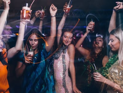 Group of women celebrating on a Las Vegas bachelorette party bus crawl with drinks and dancing.