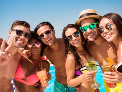 Group of friends enjoying drinks and sun during a Las Vegas private dayclub crawl with poolside fun.