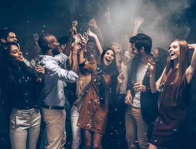 Group enjoying a lively Vegas party bus crawl with drinks and confetti.