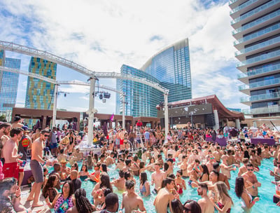 Group of people enjoying a lively Las Vegas dayclub with poolside partying and a vibrant atmosphere.