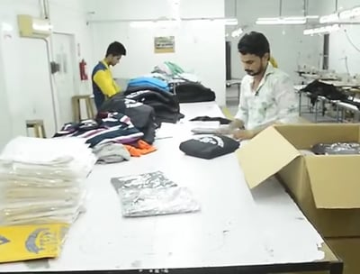 Stacked tactical uniforms and outdoor clothing ready for global delivery from Zestlet.