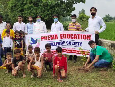 a group of people helping in tree plantation