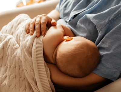 a baby is laying on a couch with a baby