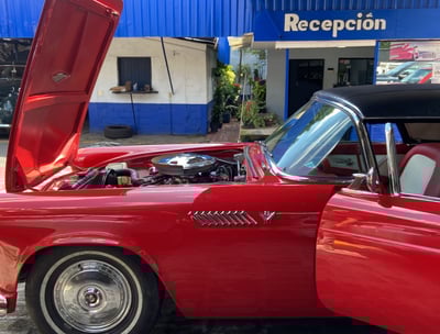 a red car with a red car hood up