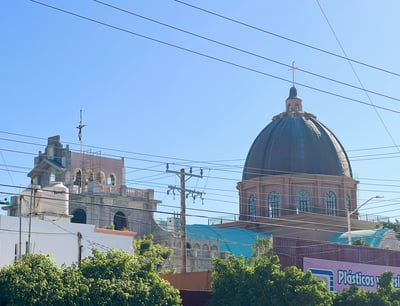 a church with a dome shaped building in the background