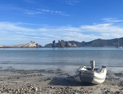 a boat on the shore of a bay