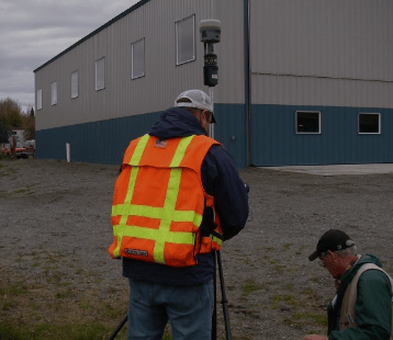 a man in a safety vest and a camera