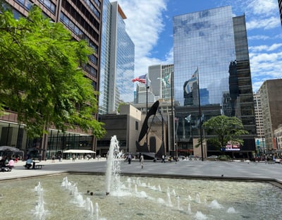 A fountain in front of skyscrapers