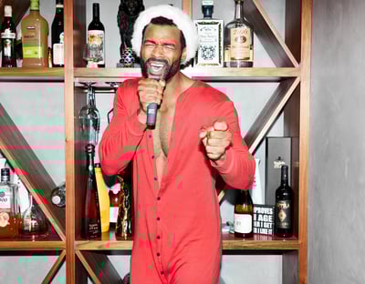 a man in a red suit and ballber pro body trimmer for men