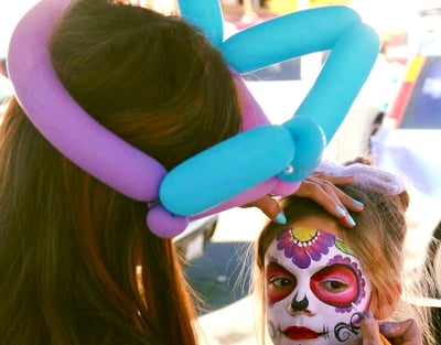 Caroline Face Painting a Sugar Skull for Day of the Dead Event