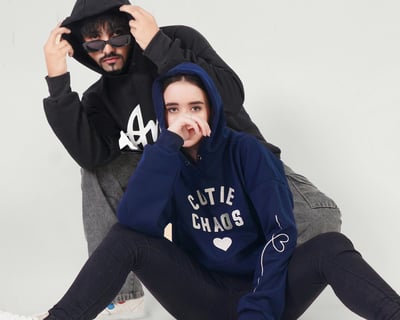 2 people wearing customized hoodies