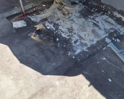 Flat slab with exposed steel and concrete spalling due to waterproofing failure