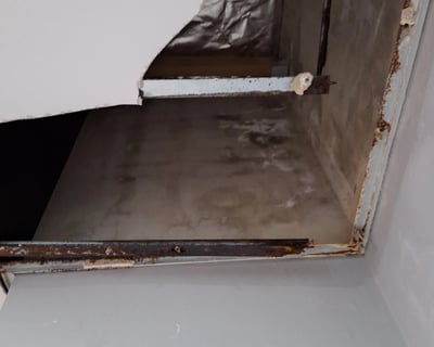 Ceiling water damage caused by slab joint leak and failed roof membrane