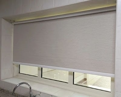 Modern blackout roller blind fully extended blocking out sunlight for complete privacy 