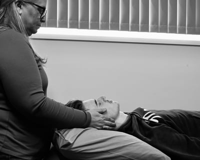 Woman giving Reiki to man