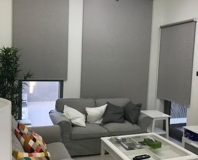 Modern blackout roller blind fully extended blocking out sunlight for complete privacy 