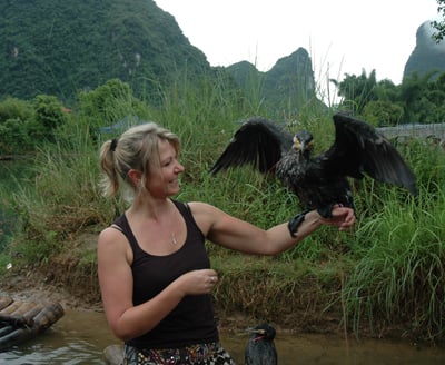 Tracey Billington with the cormorant fisherman at the Yulonghe scenic area, near Yangshuo, China