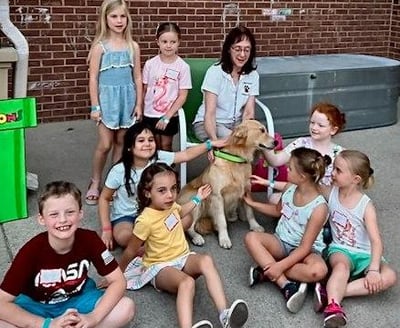 Kids visiting with Pet Partners Therapy Dog Team Ana and Lori.