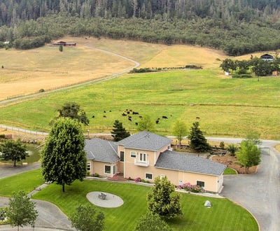 a large house with a large yard and a large field