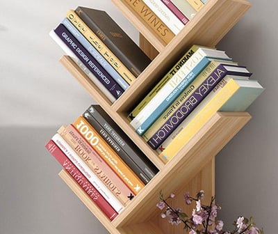 a book shelf with books and a vase with flowers