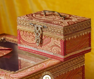 a pair of wedding boxes with a clock on top